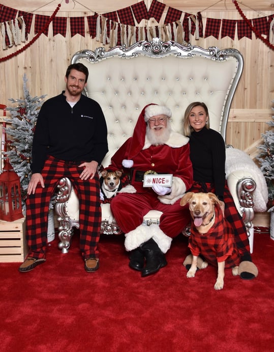 couple with dogs in photo with santa