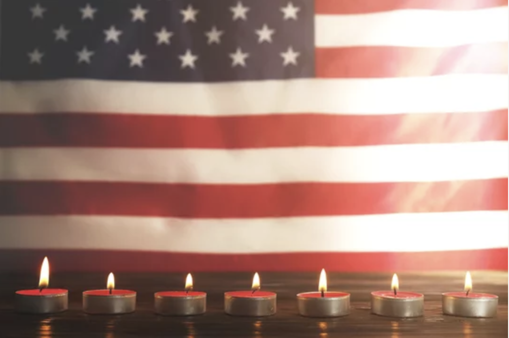 candles in front of american flag memorial
