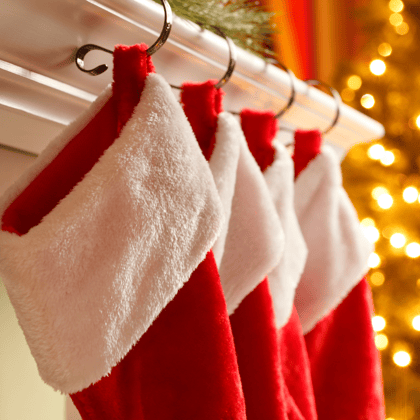 Red and White Stockings hanging on a mantel.. 