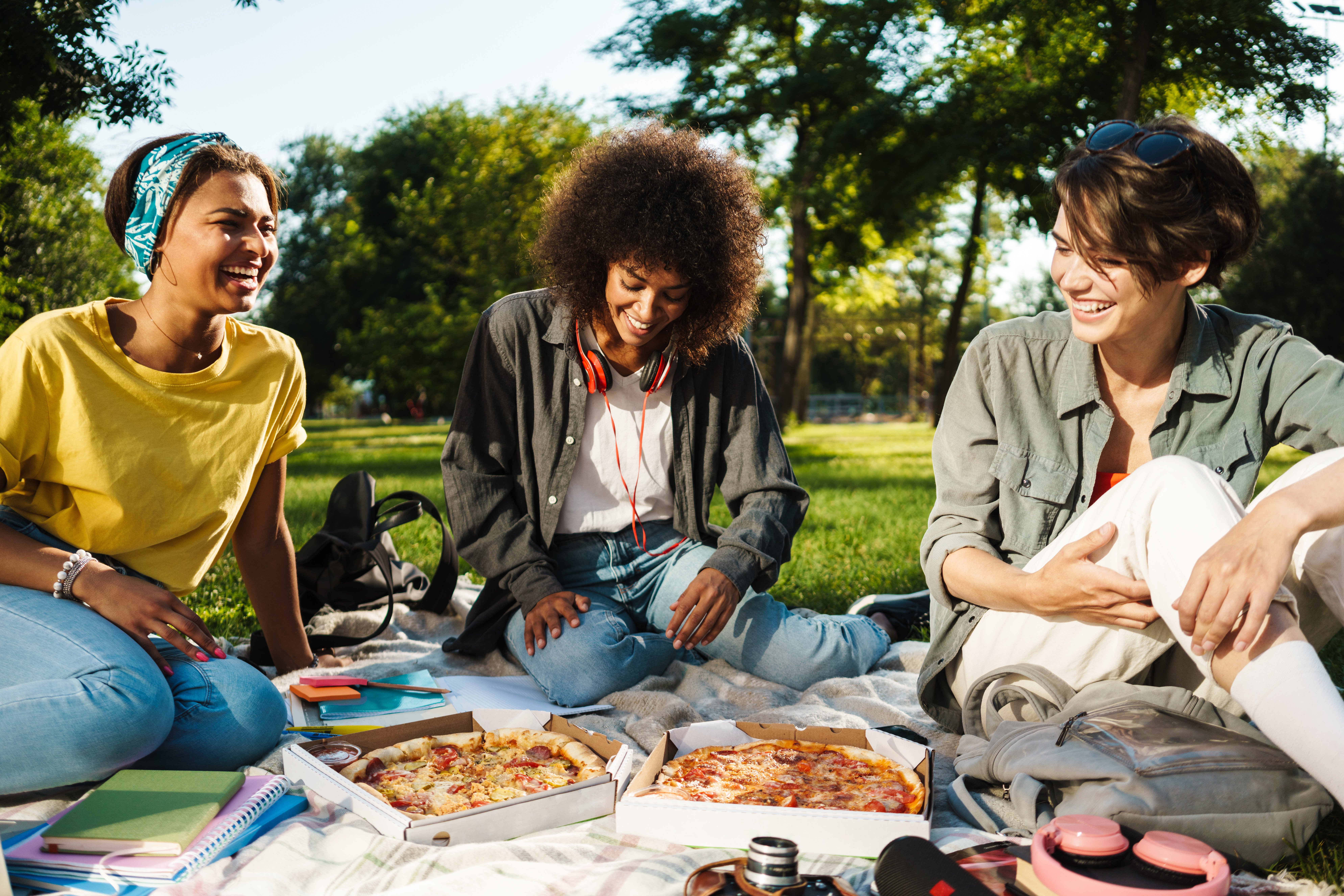 group-of-three-women-having-a-picnic-outside-in-warm-sunny-weather