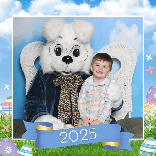Adorable little boy wearing a plaid pastel shirt and sitting on the Easter Bunnys lap