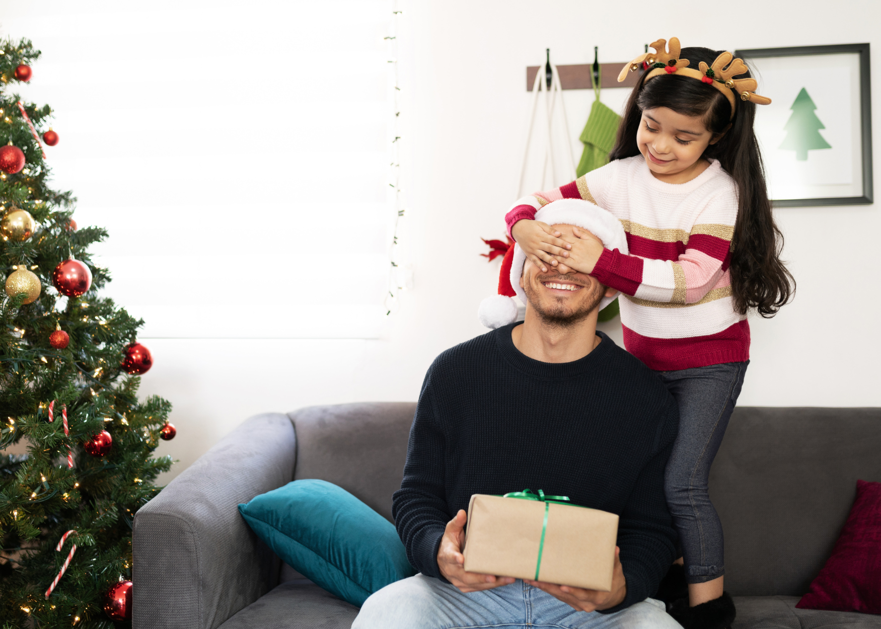 Little girl giving her dad a Christmas gift