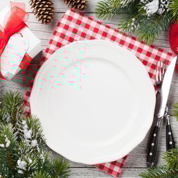 Christmas plate setting at a table.