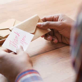 A girl writing a thank you note.