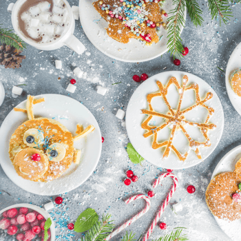 Christmas Breakfast featuring reindeer and snowflake shaped pancaked with hot chocolate.