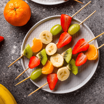 Sliced fruit on skewers.