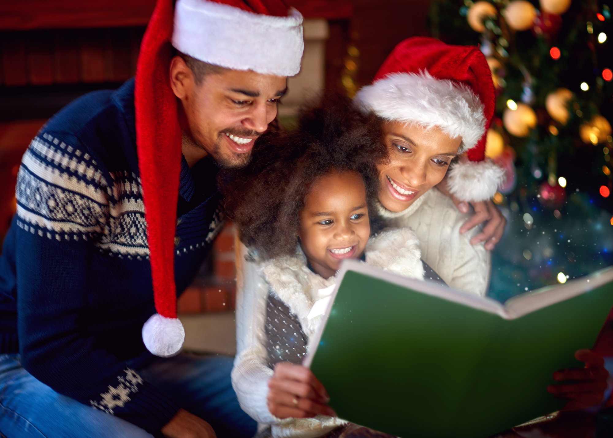 Family reading a book during Christmastime