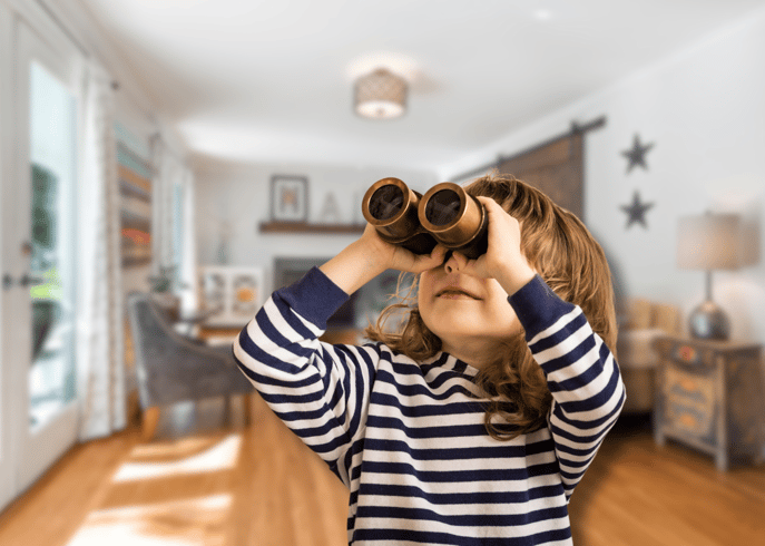 A child with binoculars in a house