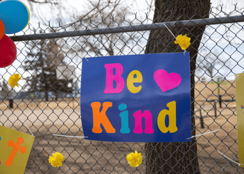 be kind poster on fence