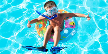 boy-float-in-innertube-in-pool-flippers-snorkle-mask-summer-splash