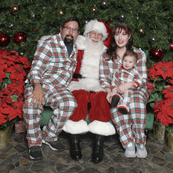 A family with Santa Claus in their Christmas PJ's