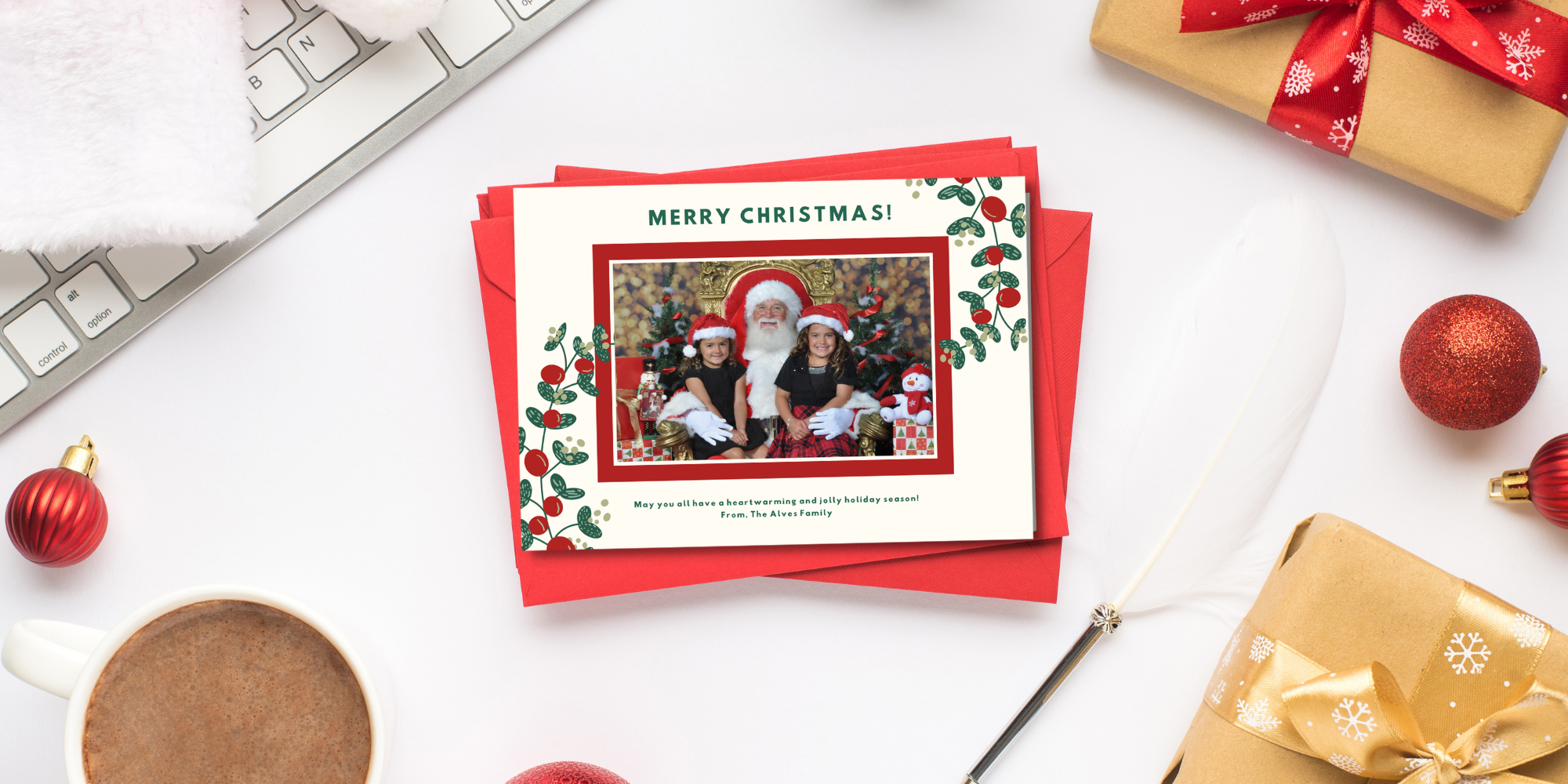 custom christmas cards with Santa visit photos on a desk with holiday presents and a computer keyboard